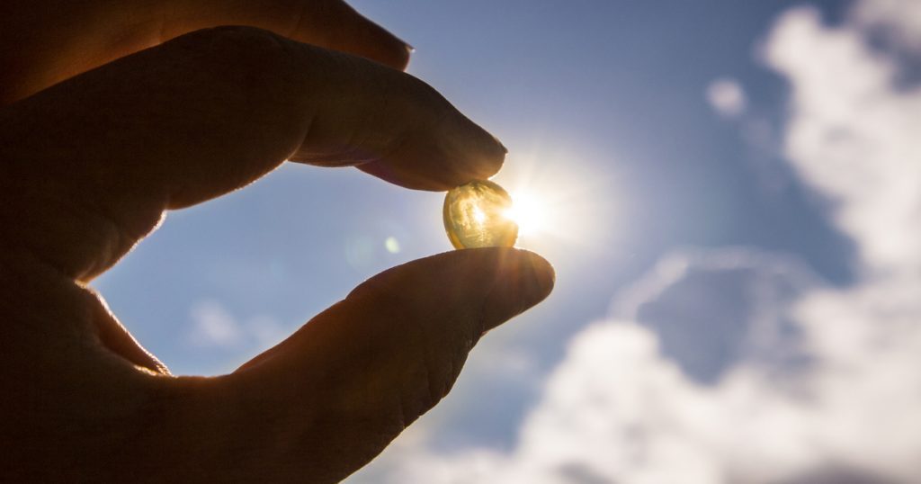 Vitamin D capsule against the sun