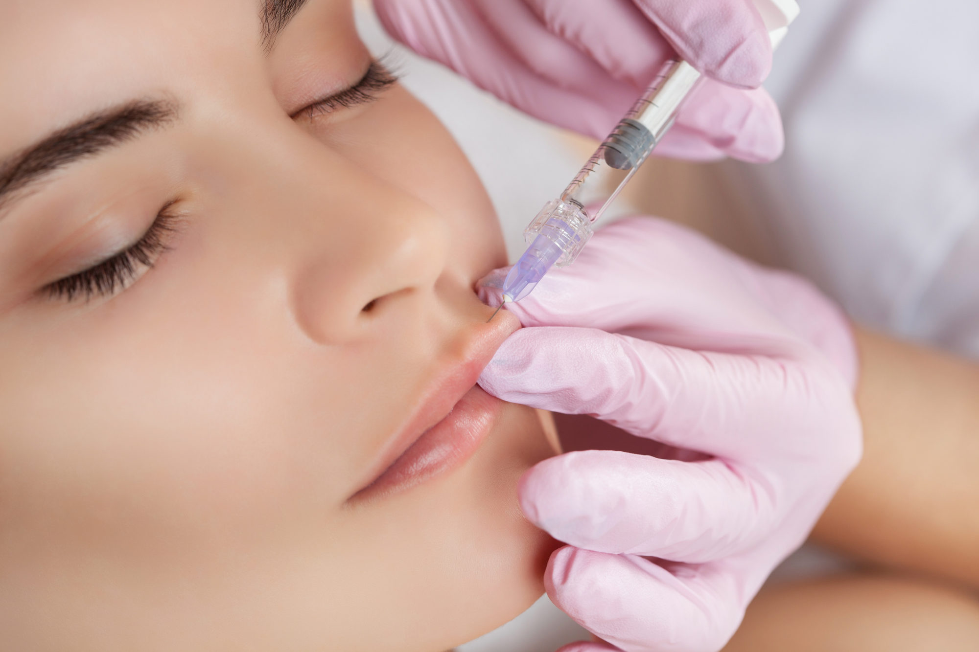 Woman receiving a lip injection