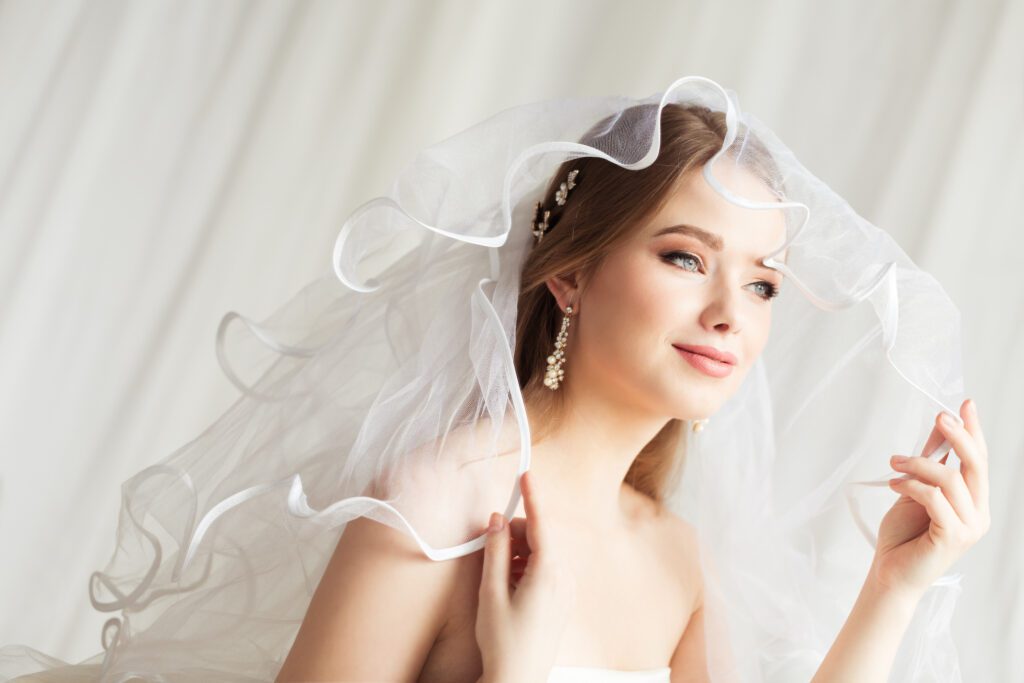 Bride in her wedding veil with beautiful, glowing skin